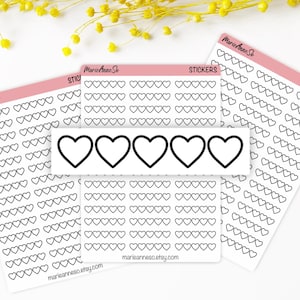 May include: Several sticker sheets with heart designs. The stickers are white with black outlines. One sheet has a row of five large hearts. The text "MarieAnneSo" and "stickers" are visible. The website marieanneso.etsy.com is also visible.