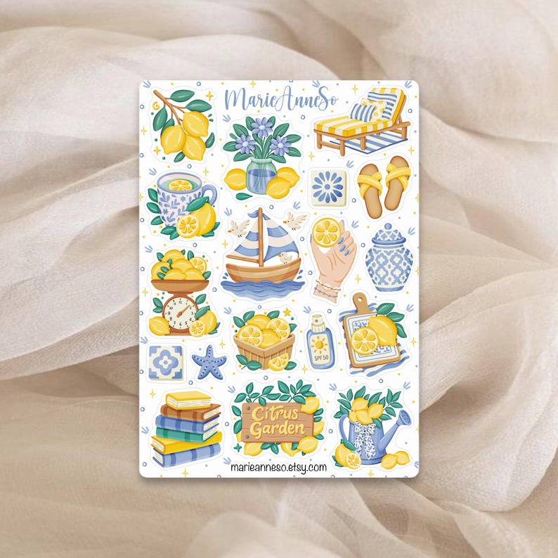 May include: A sticker sheet featuring various illustrations with a citrus theme. The designs include lemons, a sailboat, a lounge chair, and the text "Citrus Garden". The color palette is primarily yellow, blue, and white.