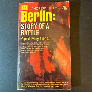 May include: A vintage paperback book titled "Berlin: Story of a Battle, April-May 1945" by Andrew Tully. The cover features a red and orange background with bold yellow lettering. The book is a historical account of the fall of Berlin.