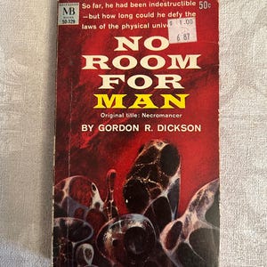 May include: Vintage paperback book titled "No Room For Man" by Gordon R. Dickson. The cover features a red background with white and yellow text. The cover art depicts abstract, organic shapes in shades of black, white, and brown.