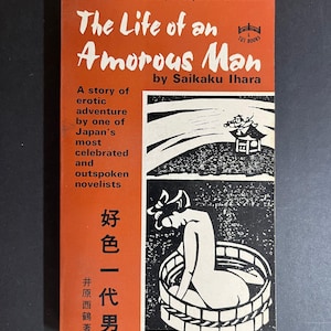 May include: A paperback book titled The Life of an Amorous Man by Saikaku Ihara with an orange cover. The cover features black and white illustrations of a person in a wooden tub and a small building, along with Japanese text and the Tut Books logo.