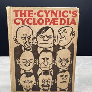 May include: A vintage book with a brown cover, titled "THE CYNIC'S CYCLOPAEDIA". The cover displays cartoon illustrations of nine men in suits with stern expressions. The title is in red, bold letters.
