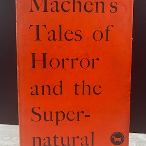 May include: A red book cover with the title "Machen's Tales of Horror and the Supernatural" in black text. A small black and white logo is in the bottom right corner.