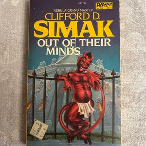 May include: A vintage paperback book titled "Out of Their Minds" by Clifford D. Simak. The cover features a red devil-like creature in front of a building. The book has a PAW print and a Goodwill price tag.