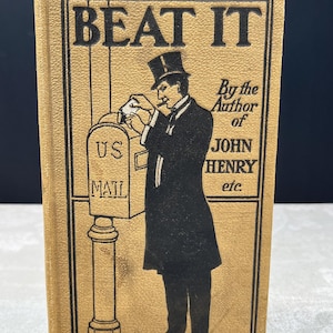 May include: A vintage book with a tan cover, featuring the title "BEAT IT" in bold black letters. The cover illustration depicts a man in a top hat posting a letter. Text reads "By the Author of JOHN HENRY etc."