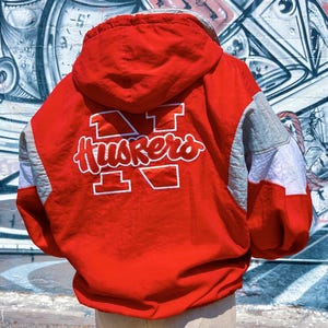 NEBRASKA CORNHUSKERS NCAA Vintage Starter Jacket size Large | Red White and Grey with Retro Logo Embroidery Quarter Length Zip