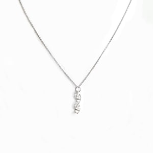 May include: A silver chain necklace with a small, silver pendant shaped like a double helix.