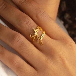 May include: Gold ring with the names "Sydney" and "Liam" written in cursive.