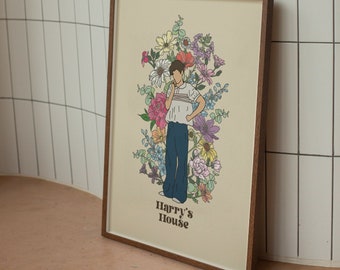 Op de afbeelding: Een ingelijste print met een kleurrijke illustratie van een persoon die in een bloemenveld staat. De tekst "Harry's House" staat onderaan de print.