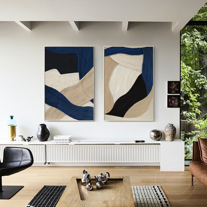 Set of 2 dark blue and beige abstract plaster paintings with 3D textured geometric and organic shapes. Minimalist navy blue art decor perfect for modern interiors.