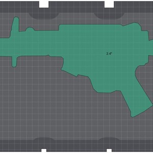 May include: A green, gun-shaped object, approximately 2.4 inches in length, is displayed on a gray grid background. The object's outline is clearly defined, and the grid provides a visual scale. The overall design is simple and graphic.