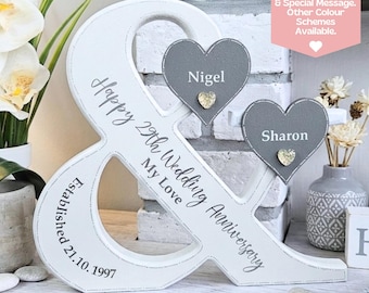 May include: A white wooden ampersand sign featuring the text Happy 29th Wedding Anniversary MY LOVE and Established 21.10.1997. Two grey heart-shaped plaques are attached, displaying the names Nigel and Sharon with small gold heart accents.