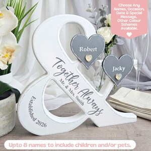 May include: A white wooden ampersand-shaped sign with the words "Together Always" and "Established 2026." Two grey heart-shaped name tags read "Robert" and "Jacky." The sign includes the text "Choose Any Names, Occasion, Date & Special Message."