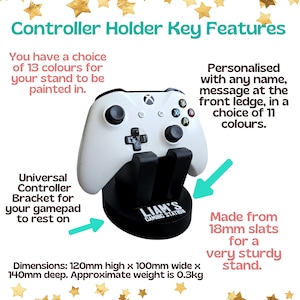 May include: A white video game controller sits in a black stand with a black base. The base is engraved with "Liam's Gaming Station". The stand is made from 18mm slats and is 120mm high, 100mm wide, and 140mm deep. The stand is available in 13 colours and can be personalised with a name or message in 11 colours.