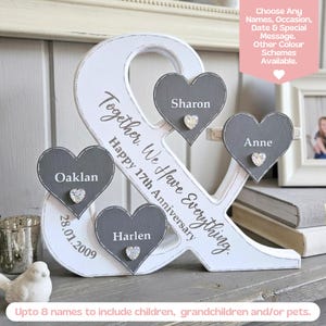 May include: A white wooden ampersand sign featuring three grey heart-shaped plaques with the names Sharon, Anne, and Harlen. The sign includes the text Together, We Have Everything, Happy 17th Anniversary, and the date 28.01.2009, with small crystal accents.