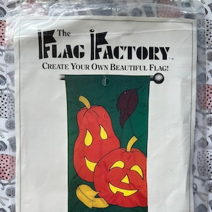 May include: A sewing pattern for a happy pumpkin flag. The pattern is for a 28" x 49" flag and includes instructions for sewing the flag. The pattern is from The Flag Factory, a division of Mutual Industries.