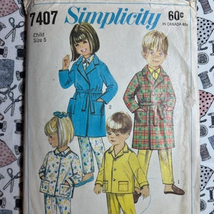 May include: Simplicity sewing pattern number 7407 for children's pajamas. The pattern includes three different styles: a blue robe with a belt, a plaid robe with a belt, and a yellow pajama set. The pattern is for child size 5 and costs 60 cents.