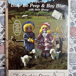 May include: A vintage sewing pattern for making a 22-inch doll, titled "Little Bo Peep & Boy Blue with their Sheep." The pattern is from The Gingham Goose Patterns & Pretties, Inc. and includes instructions for making a doll, sheep, and accessories.