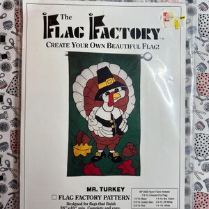 May include: A sewing pattern for a Mr. Turkey flag. The pattern is designed to finish at 28 inches by 49 inches. The pattern includes instructions for sewing the flag. The pattern is from The Flag Factory, a division of Mutual Industries.