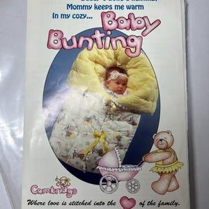 May include: A baby bunting advertisement featuring a baby wrapped in a yellow and white quilted blanket. The text reads "Mommy's going shopping, Daddy's gone a hunting, Mommy keeps me warm." A teddy bear pushes a pink stroller.