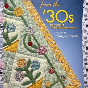 May include: A book titled "THREADS from the '30s" featuring quilts using reproduction fabrics. The cover displays a colorful quilt design with floral patterns in yellow, blue, and red. Compiled by Nancy J. Martin.