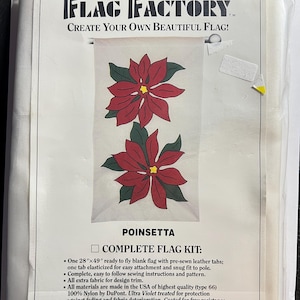 May include: A complete flag kit featuring a poinsettia design. The kit includes a 28" x 49" blank flag with pre-sewn leather tabs, sewing instructions, and extra fabric for design trim. The flag is made in the USA with UV-treated nylon for fade resistance.
