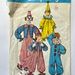 May include: Vintage Simplicity sewing pattern 7162 for boys and girls clown costumes. The pattern features illustrations of four different clown outfits in blue, yellow, and red, with striped pants and ruffled collars. The pattern size is 6-8.