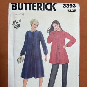 May include: A vintage Butterick sewing pattern, featuring illustrations of two women's outfits. One woman wears a navy blue dress with a pleated front, and the other wears a red jacket with black pants. The pattern number is 3393, size 14.