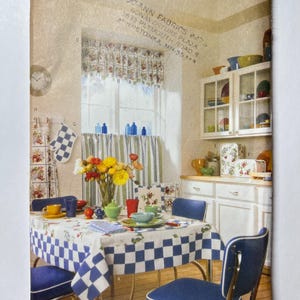 May include: A vintage Butterick pattern envelope featuring a kitchen scene. The scene includes a table set with a blue and white checkered tablecloth, matching chairs, and floral curtains. The envelope has the text "Butterick" and "One Size".