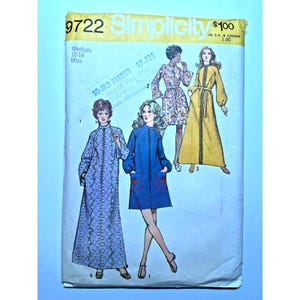 May include: Vintage Simplicity sewing pattern 9722 for Misses' dresses. The pattern envelope features illustrations of the finished garments, including a long floral dress, a blue coat dress with heart pockets, and a yellow dress with a belt.