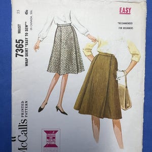 May include: Vintage McCall's sewing pattern for a wrap skirt, labeled "Easy to Sew" and "Recommended for Beginners." The cover features illustrations of the skirt in different fabrics. The pattern number is 7365, with a waist size of 25.