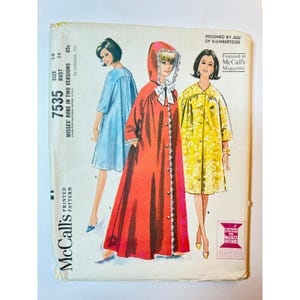 May include: A vintage McCall's sewing pattern envelope, number 7535, for a misses' robe in two versions. The illustration shows three figures wearing a light blue short robe, a long red hooded robe with a white bow, and a yellow patterned robe.