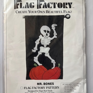 May include: A packaged flag pattern from The Flag Factory. The design features a white skeleton figure with red pumpkins on a black background. The text "MR. BONES" is visible, along with instructions for a 28" x 49" flag.