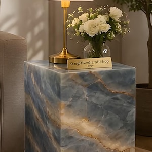 May include: A set of three ceramic mugs with a speckled, matte finish. The mugs are in shades of cream, light gray, and dark gray. Each mug has a simple, minimalist design, perfect for coffee or tea.