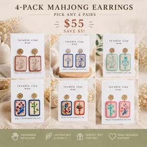 May include: A collection of six pairs of Mahjong earrings, each with a unique design. The earrings feature gold-colored studs and rectangular pendants with colorful illustrations. The text "4-PACK MAHJONG EARRINGS" is at the top.