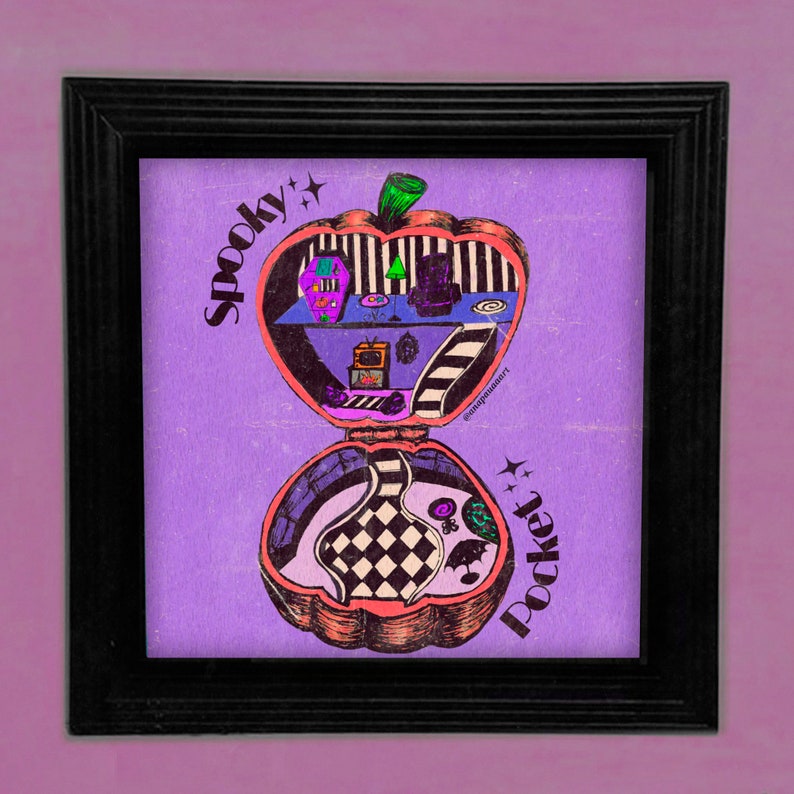 May include: A purple and pink illustration of a spooky compact mirror with a black and white checkered interior. The compact is shaped like an apple and has the words "Spooky Pocket" written on it.