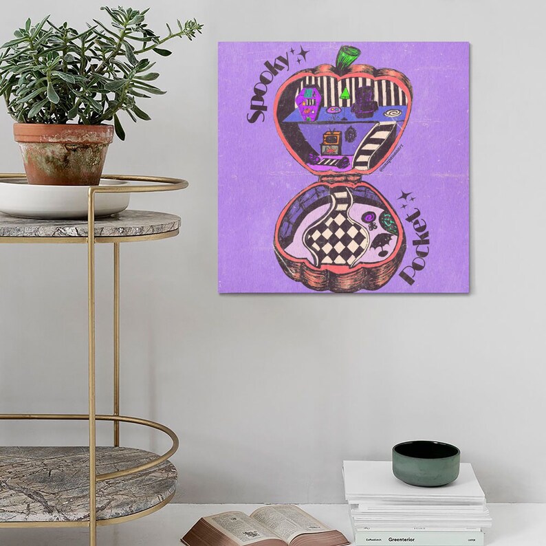 May include: A purple background with a cartoon illustration of a pumpkin shaped pocket-sized house with the words "Spooky Pocket" written on it.