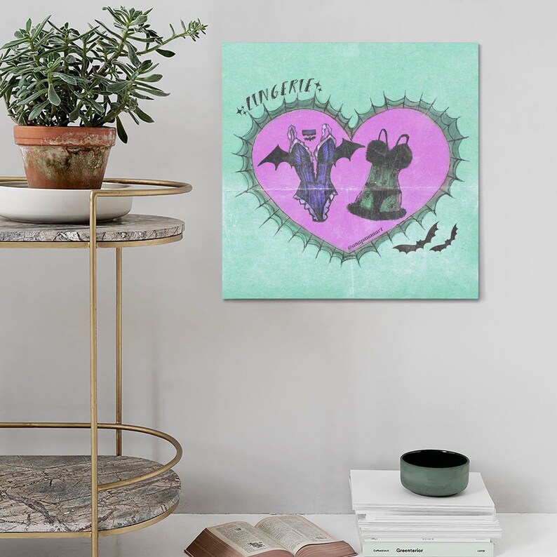 May include: A green and pink illustration of lingerie in the shape of a heart with bats and the word "LINGERIE" at the top.