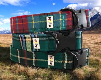 May include: Three plaid dog collars in red, green, and blue. Each collar has a black plastic buckle and a metal D-ring. The collars are stacked on top of each other, showcasing the different color patterns.