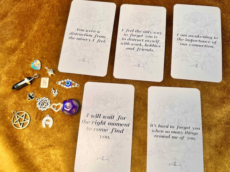May include: Five white cards with black text on a gold background. The cards have quotes about love, loss, and connection.  The text on the cards reads: "You were a distraction from the misery I feel." "I feel the only way to forget you is to distract myself with work, hobbies and friends." "I am awakening to the importance of our connection." "I will wait for the right moment to come find you." "It's hard to forget you when so many things remind me of you."