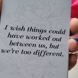 May include: A white card with a floral design and the text "I wish things could have worked out between us, but we're too different."