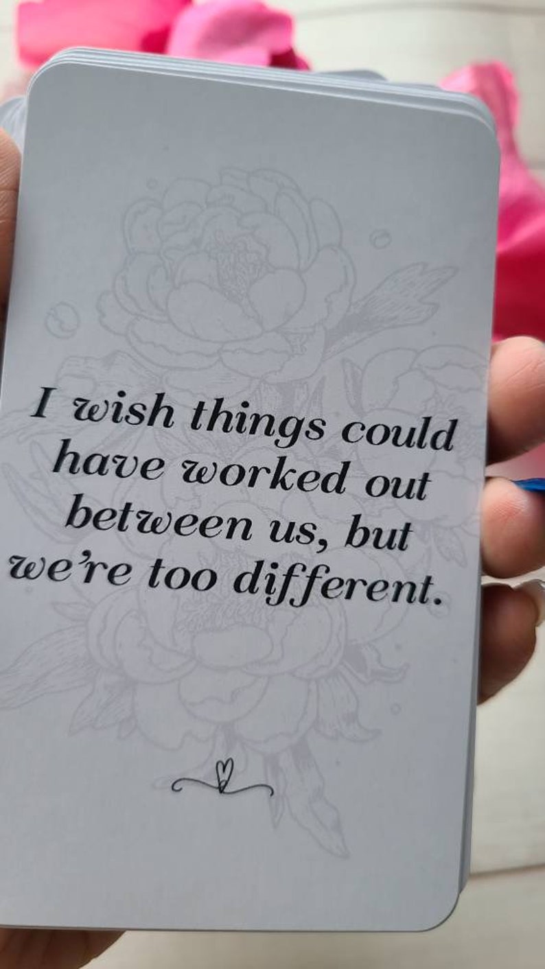 May include: A white card with a floral design and the text "I wish things could have worked out between us, but we're too different."