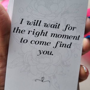 May include: A white card with a floral design and the text "I will wait for the right moment to come find you."