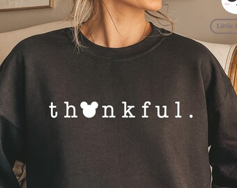 May include: Black sweatshirt with the text "thankful" in white with a white Mickey Mouse head replacing the "o" in the word.