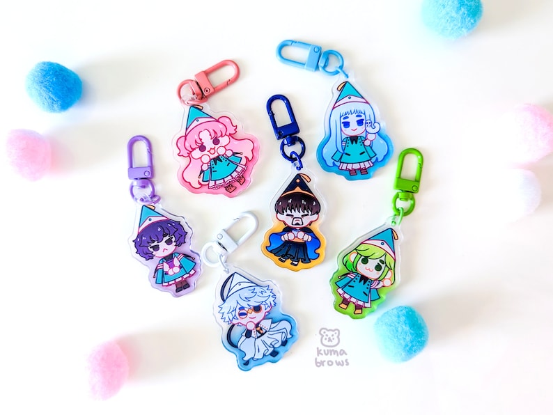 May include: Seven colorful character charms with keychains. Each charm features a different anime-style character wearing a hat and a green outfit. The charms are made of clear acrylic and have a glossy finish.