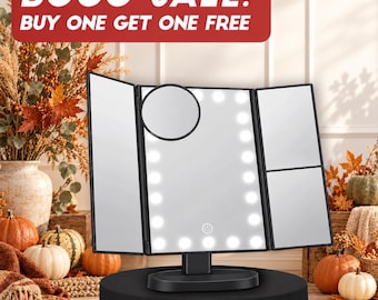 May include: A black tri-fold vanity mirror with integrated LED lights, a central touch-sensitive power button, and a small circular magnifying mirror attachment. The text BOGO SALE! BUY ONE GET ONE FREE is displayed in a red banner at the top.