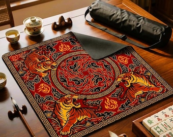 May include: A square desk mat featuring a vibrant red background with three roaring tigers, swirling flame patterns, and a geometric border. The mat is accompanied by a black cylindrical carrying case, a calligraphy brush, and a small ceramic tea cup.