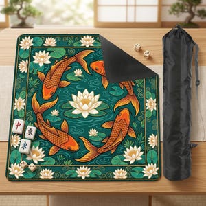 May include: A rectangular game mat featuring a teal background with orange koi fish swimming around white lotus flowers. The mat includes dice and game tiles. A black carrying bag is on the right.