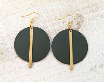 May include: A pair of green leather earrings with gold accents. Each earring features a round green leather disc with a vertical gold bar.