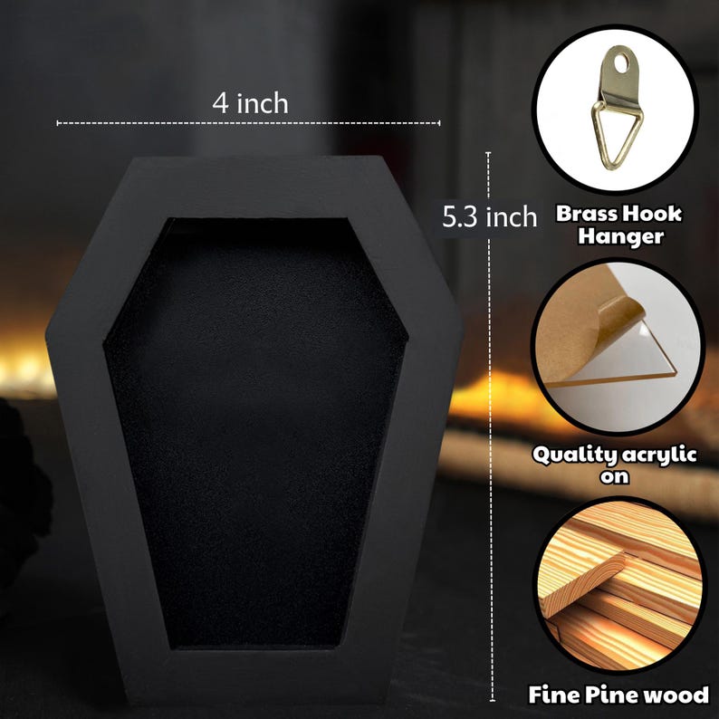 May include: A black coffin-shaped display box measuring 4 inches wide by 5.3 inches tall. It features a brass hook hanger, a clear acrylic front panel, and is constructed from fine pine wood. The interior is matte black with a deep recessed area.